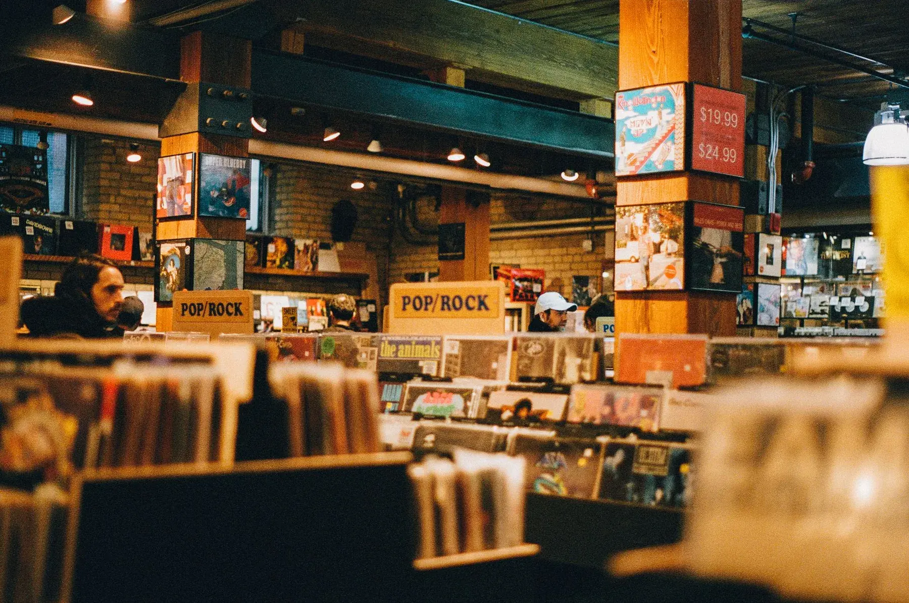 Inside a record shop, in warm light.