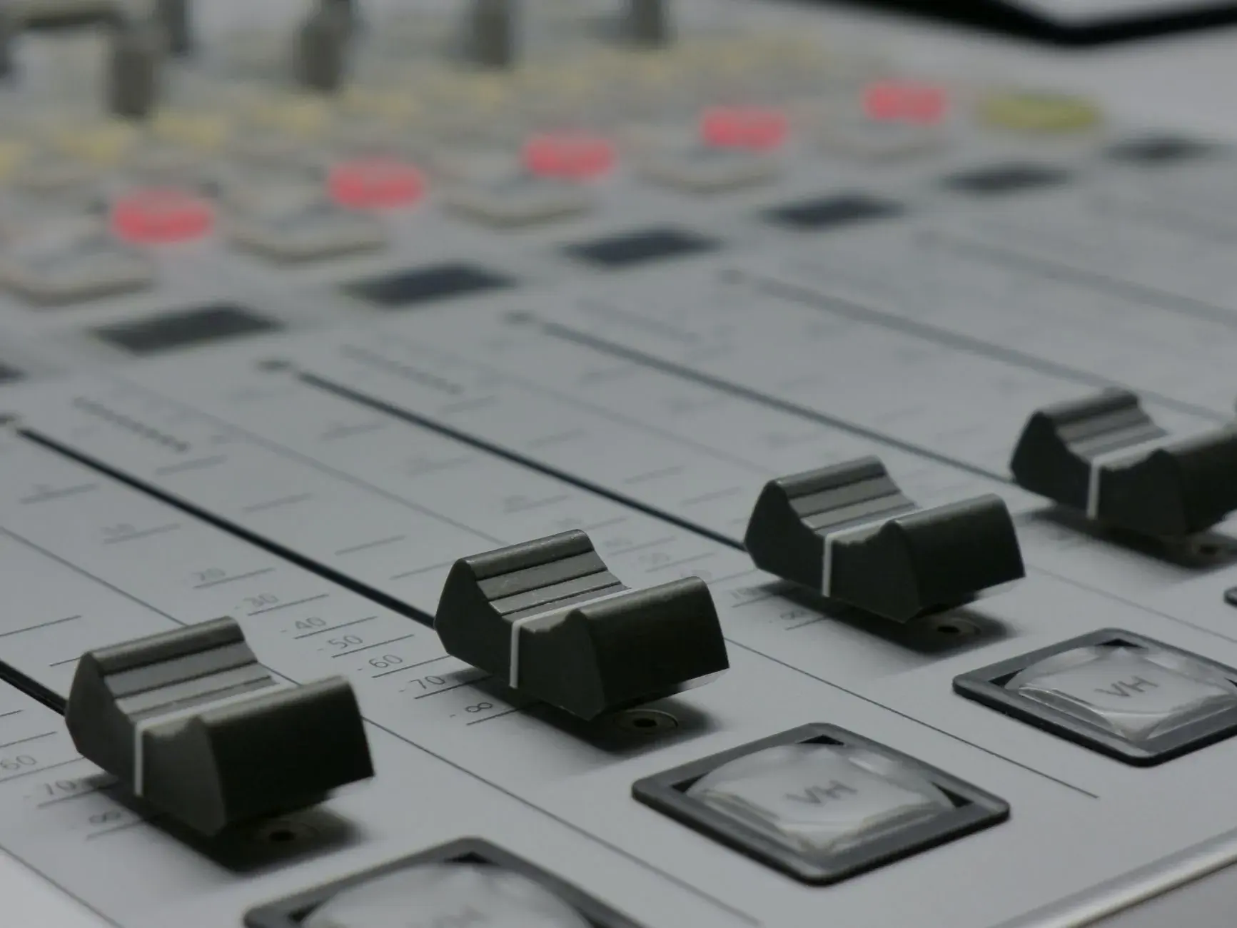 Close-up of a mixing desk's faders.